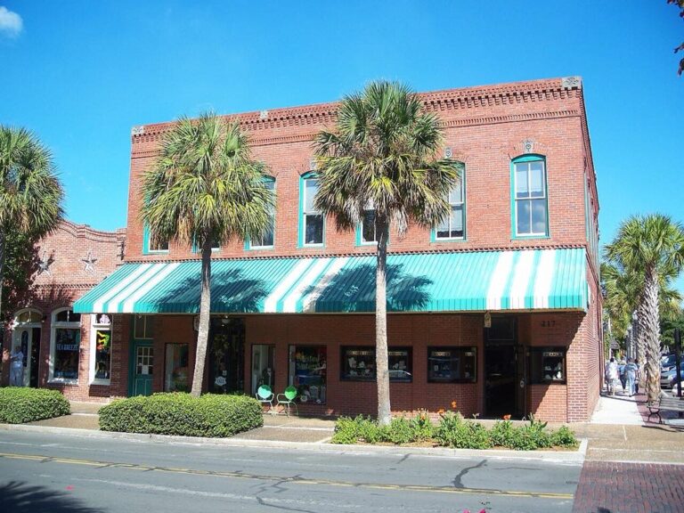 Historic brick storefronts and palm trees on Centre Street in downtown Fernandina Beach, Florida