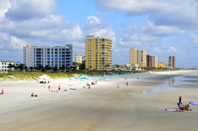 Jacksonville Beach, Florida shoreline with beachgoers and umbrellas on a summer day